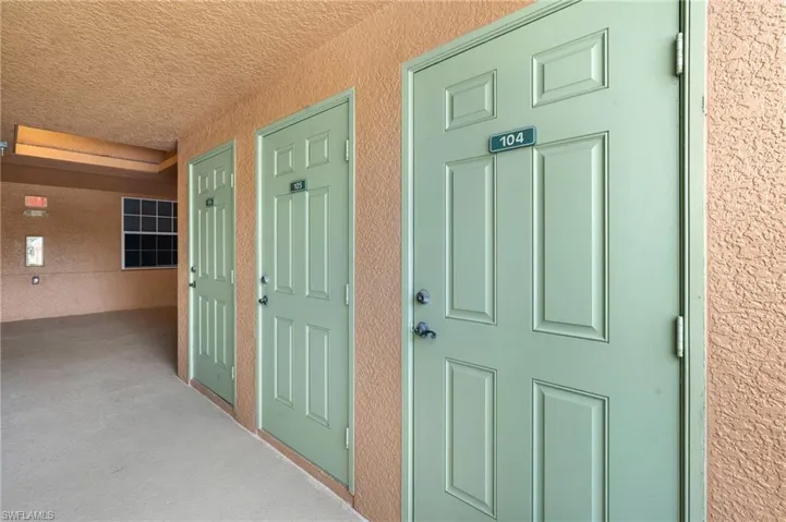 Entrance to property featuring stucco siding