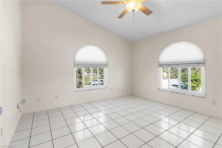 Guest bedroom with dual arched windows