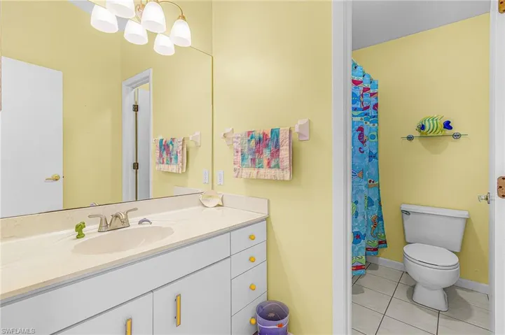 Guest bath featuring separated shower/toilet and vanity areas