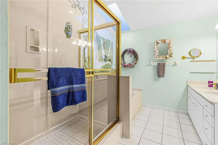 Master bathroom with separate tub and shower, plus a skylight