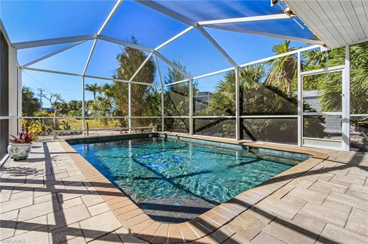 Swimming pool with a lanai and a patio area