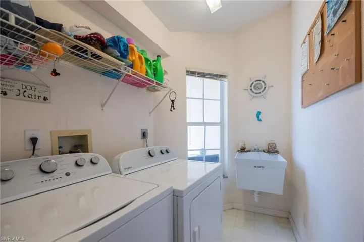 Laundry room has a utility sink and room for storage.
