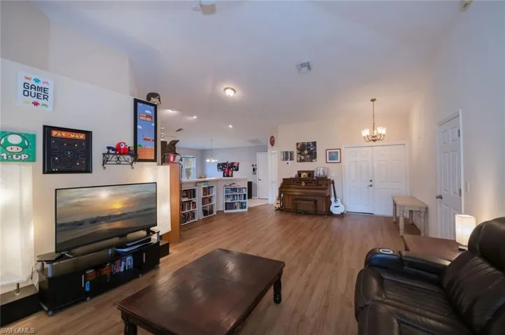 Double doors are the entrance to the home. Open space for formal dining or in this case, music room.
