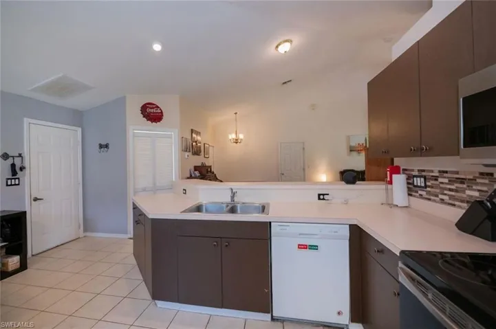Door to the left leads to the garage. Door to the right of that leads to the laundry room.