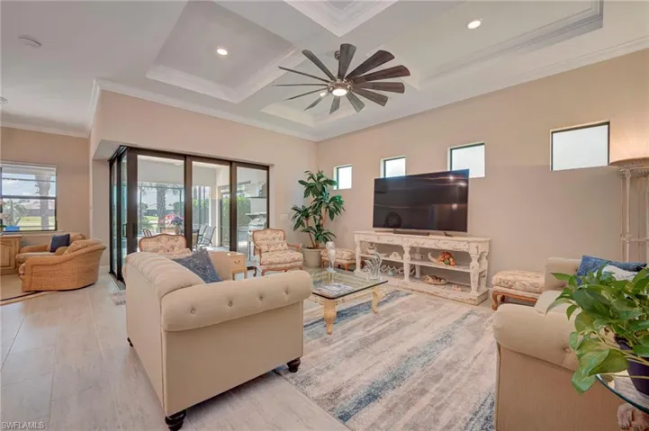 Living area with recessed lighting, coffered ceiling, crown molding, and ceiling fan