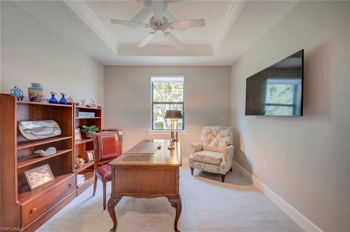 Office with a ceiling fan and crown molding