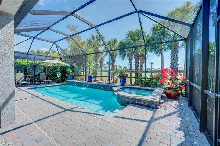 Integrated pool / hot tub featuring a lanai, and a patio area