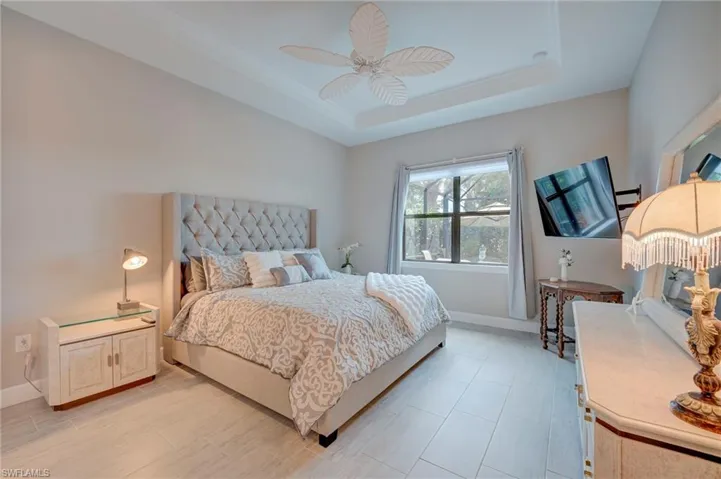 Bedroom with ceiling fan and baseboards