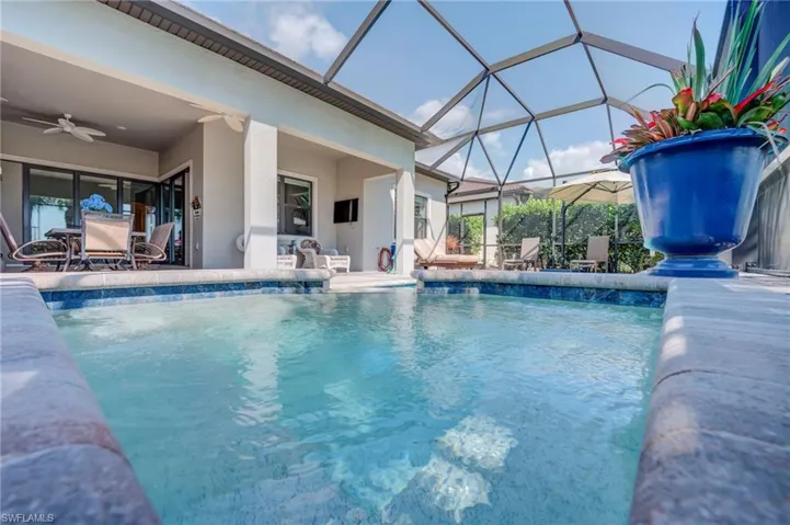 Swimming pool featuring a patio area, a lanai, and outdoor dining space