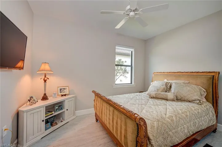 Bedroom with baseboards and a ceiling fan
