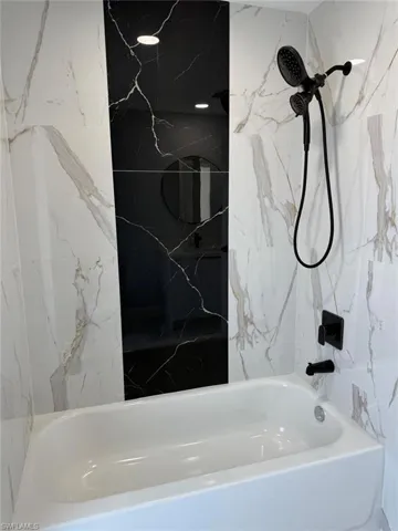 Bathroom featuring shower / washtub combination