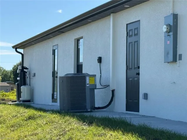 View of home's exterior with cooling unit and stucco siding