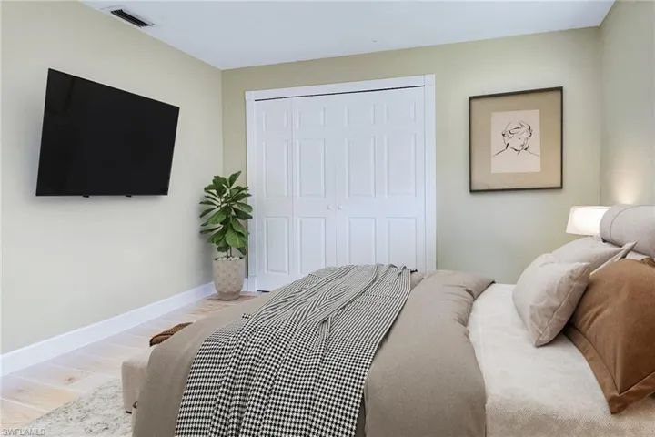 Bedroom featuring wood finished floors and a closet