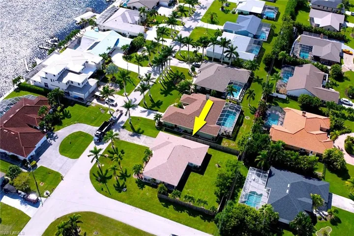 Aerial view of residential area featuring a large body of water