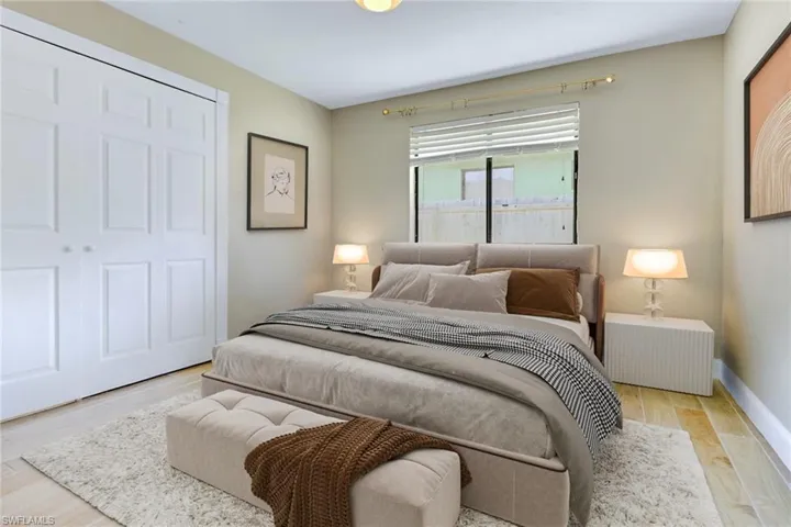 Bedroom featuring wood finished floors and a closet