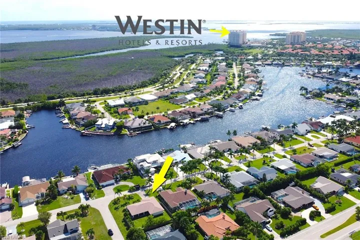 Aerial overview of property's location featuring a nearby body of water and nearby suburban area