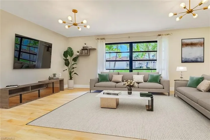 Living room featuring a chandelier and wood finished floors