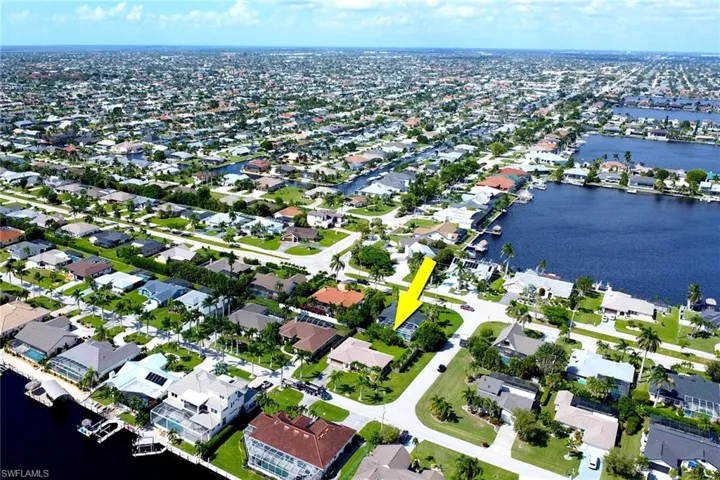 Aerial overview of property's location with a large body of water and nearby suburban area