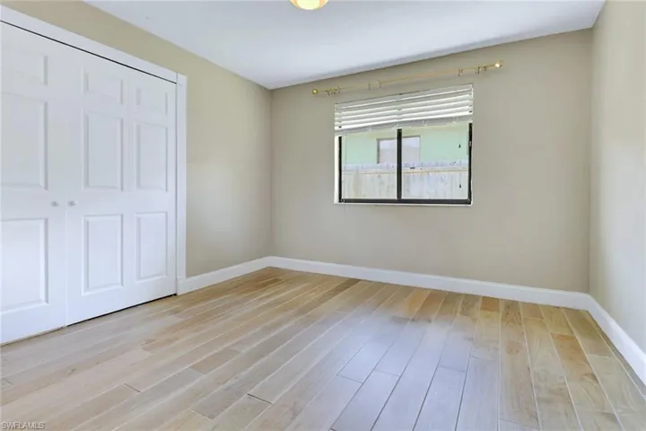 Unfurnished bedroom with a closet and light wood-style floors