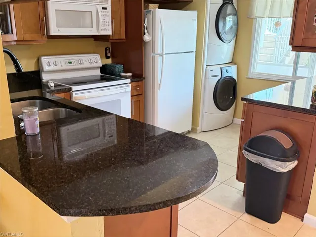 Kitchen has been updated and features wood cabinetry and granite counters.
