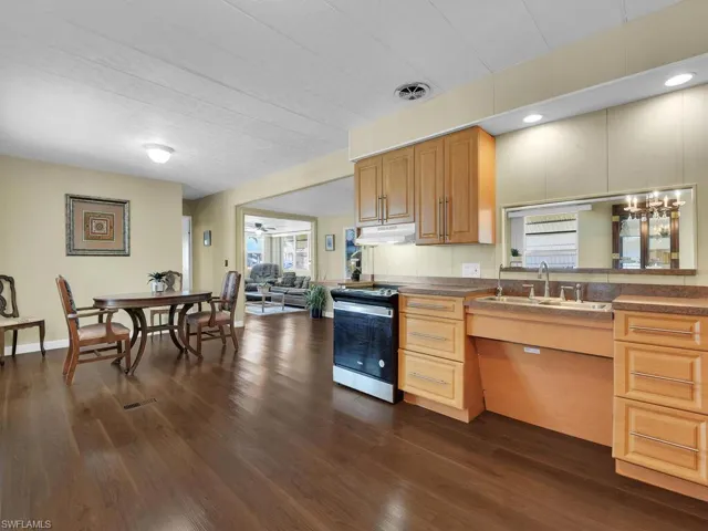 Kitchen with sink, electric range, and dark hardwood / wood-style flooring