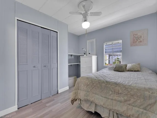 Bedroom with a closet, ceiling fan, and light hardwood / wood-style flooring