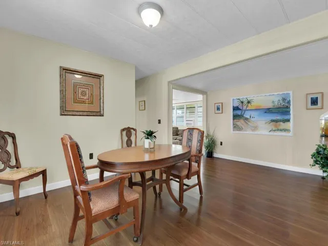 Dining space with dark hardwood / wood-style flooring