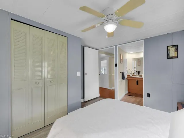 Bedroom with ceiling fan, a closet, and hardwood / wood-style floors
