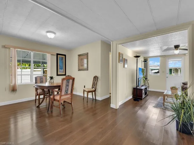 Dining room featuring a healthy amount of sunlight, ceiling fan, and dark hardwood / wood-style flooring