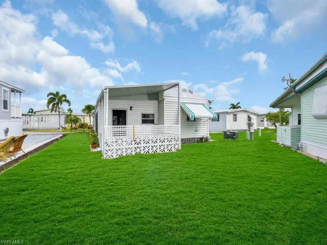 Rear view of house with a yard