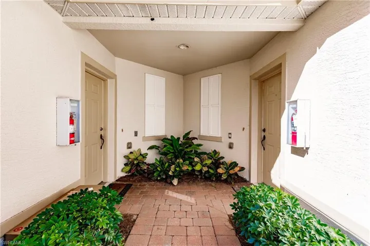 Doorway to property with stucco siding