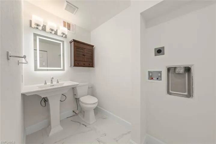 Half bath with washer/ dryer hookup