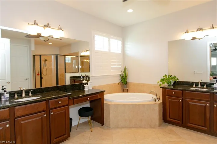 Full bath with a sink, a bath, tiled flooring, and a stall shower