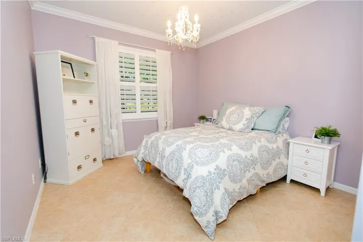 Bedroom with chandelier,  and tile floors