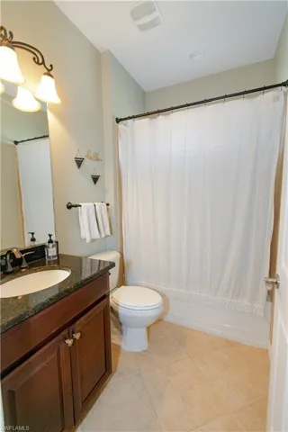 Full bath featuring vanity, tile flooring,  and shower / bath combo