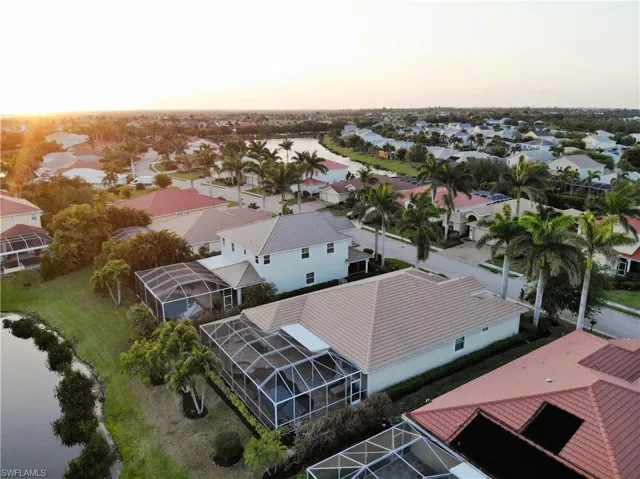 Aerial view at dusk with a water view and a residential view