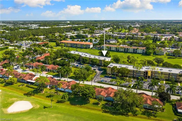 Drone / aerial view of a golf course and apartment complex