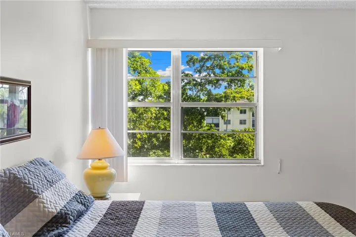 Bedroom with multiple windows and a textured ceiling