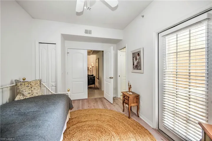 Bedroom featuring light wood finished floors, a closet, and ceiling fan