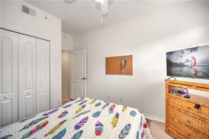 Bedroom featuring a closet, light wood-style flooring, and a ceiling fan