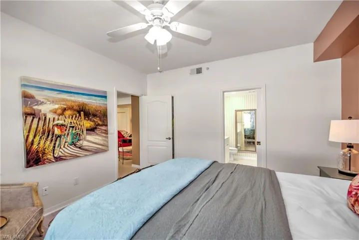 Bedroom with ceiling fan and ensuite bath