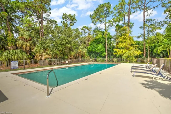 Community pool with a patio