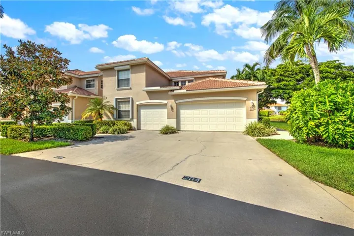 Mediterranean / spanish house with stucco siding, concrete driveway, a tile roof, and an attached garage