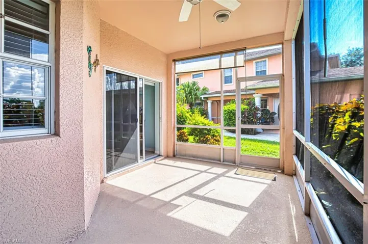 Unfurnished sunroom featuring ceiling fan