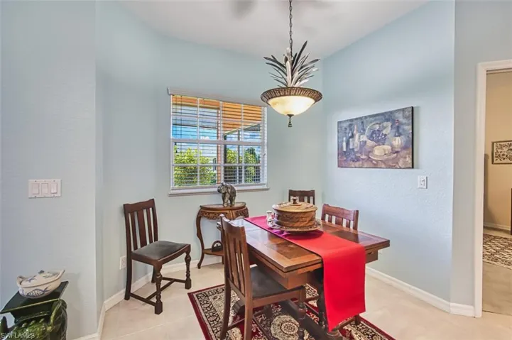 Dining room with a textured wall and light tile patterned flooring