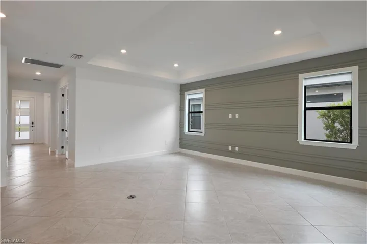 Living room featuring foyer leading to front door