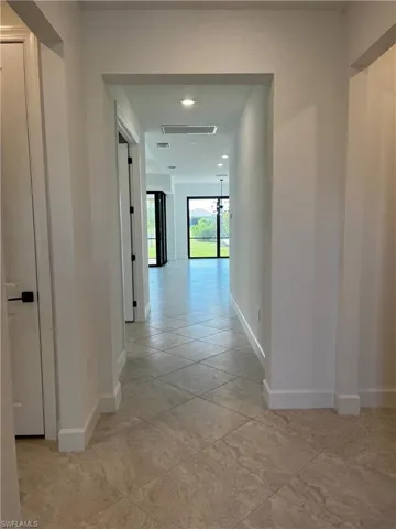Foyer leading to living room and kitchen area