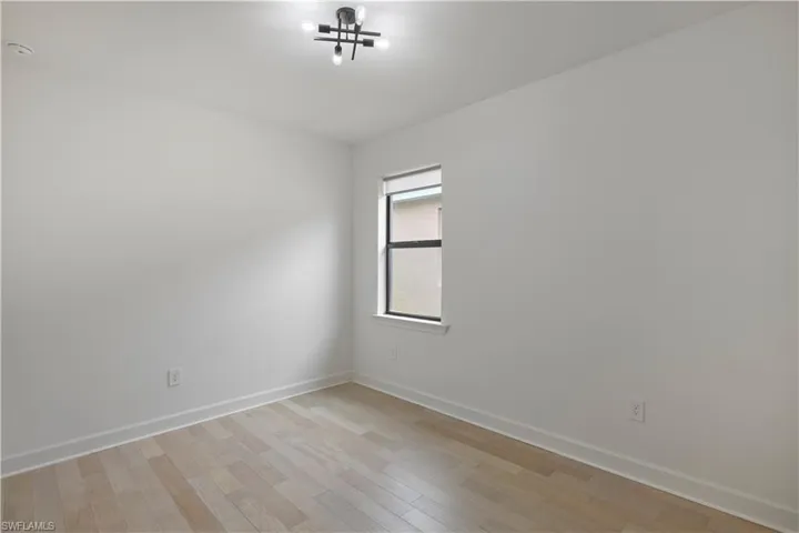 Guest room with light and hardwood floors