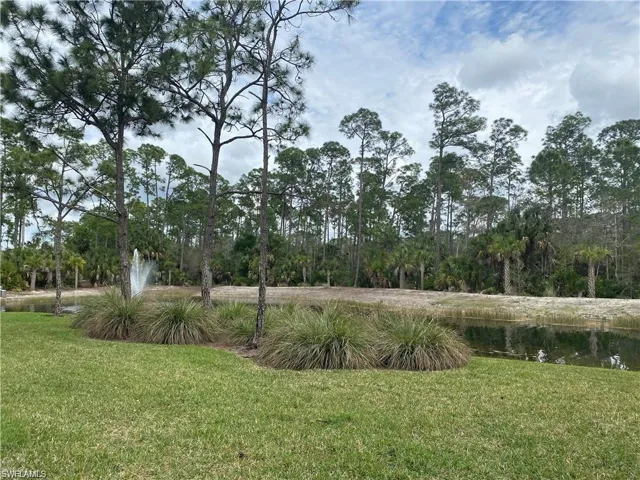 View of grassy yard with a water view