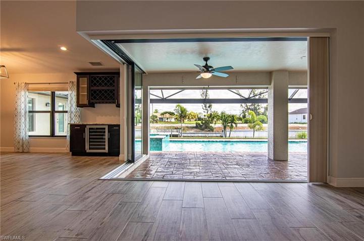 VIEW to LANAI, POOL and CANAL from LIVING ROOM